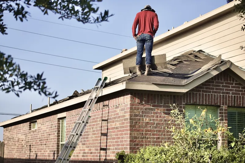 Professional roofer working on a residential roof in Harding